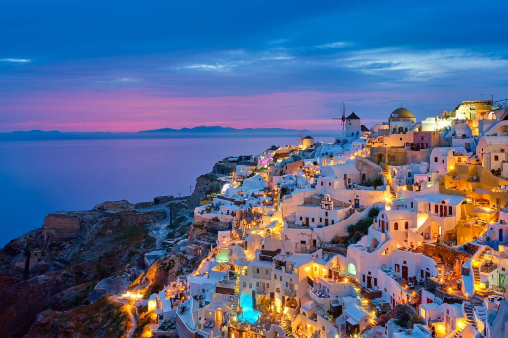 famous-greek-iconic-selfie-spot-tourist-destination-oia-village-with-traditional-white-houses-windmills-santorini-island-evening-blue-hour-greece